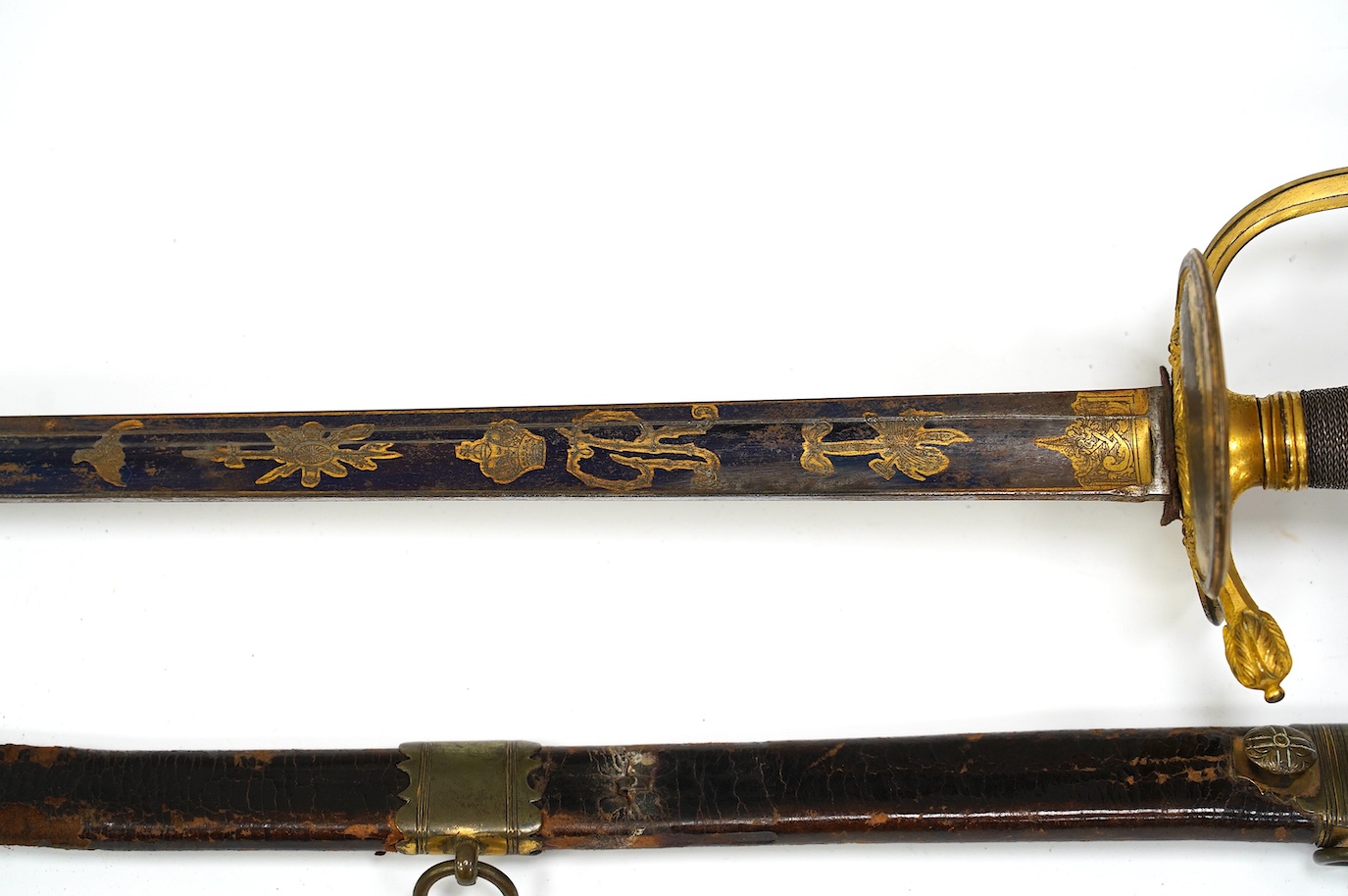 A 1796 pattern infantry officer's sword, blued and gilt blade, etched with crowned GR and Royal Arms, regulation gilt brass hilt, in its leather scabbard with brass mounts, locket signed S. Brunn, 81.5cm. Condition - goo